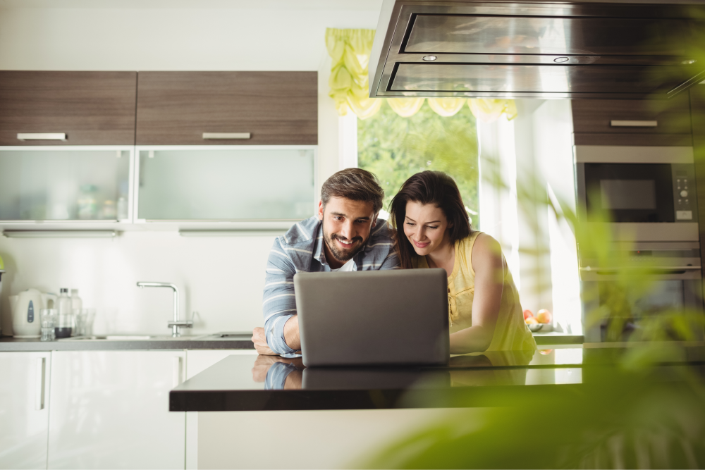 happy-couple-using-laptop-resolving-taxes